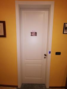 a white door with a picture on it at B&B Ad Quintum Torino in Collegno