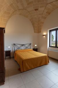 A bed or beds in a room at Masseria Giustiniani