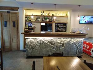 a bar in a restaurant with a large counter at Locanda Mulino del Barone by VM in Opi +27 photos