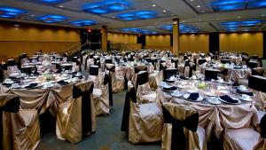 a large banquet hall with tables set up for a wedding at Crowne Plaza Hotel Glen Ellyn/Lombard, an IHG Hotel in Glen Ellyn