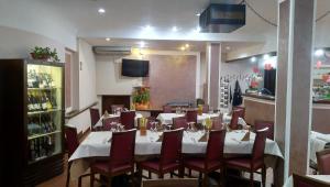 a dining room with a table and chairs in a restaurant at Hotel Franini in Costa Volpino