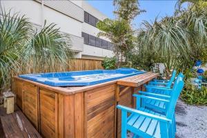 two blue chairs sitting next to a hot tub at Seahorse Suite home in Bradenton Beach