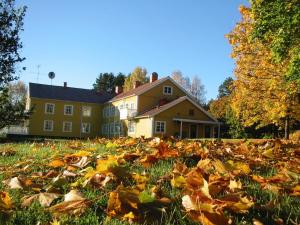 a pile of leaves in the grass in front of a house at Hotel PerOlofGården in Åsbro