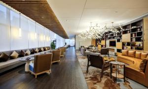 a lobby of a hotel with couches and chairs at Crowne Plaza Chengdu Wenjiang, an IHG Hotel in Chengdu