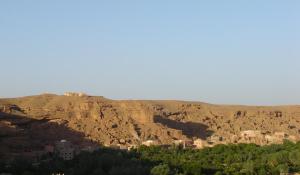 una città su una collina con montagne sullo sfondo di Dar Timitar a El Kelaa des Mgouna