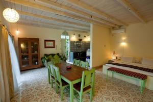 a room with a bed and a table and chairs at Villa Ruby in Yogyakarta