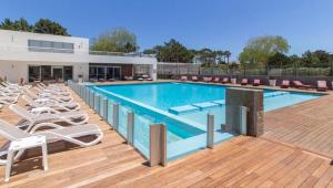 プンタ・デル・エステにあるCómodo apartamento en Torre Ocean Drive con todos los serviciosの大型スイミングプール(ラウンジチェア付)が隣接しています。 +6枚の写真