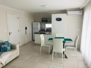 cocina y comedor con mesa y sillas en Cómodo apartamento en Torre Ocean Drive con todos los servicios en Punta del Este
