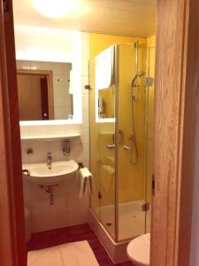 a bathroom with a shower and a sink at Isar Hotel in Freising