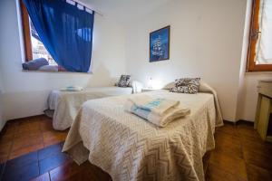 Postel nebo postele na pokoji v ubytování Casa Goletta soggiorno per 4 a 2 minuti dalla spiaggia IUNQ0334