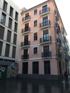 a pink building on a city street in the rain at Zerka Sendra in Valencia