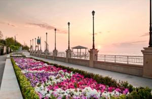 a row of flowers on a sidewalk next to a bridge at Cosy 1-bedroom apartment in Odessa in Odesa +6 photos