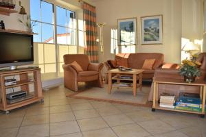 a living room with couches and a flat screen tv at Anne Marie in Barendorf