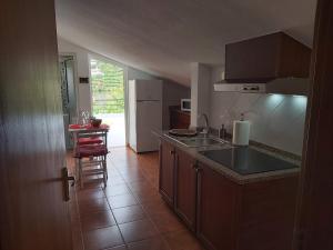 a kitchen with a sink and a counter top at Tabua Village Adventure Room #6 with Ocean View in Ribeira Brava