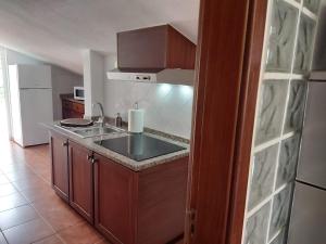 a kitchen with a sink and a counter top at Tabua Village Adventure Room #6 with Ocean View in Ribeira Brava