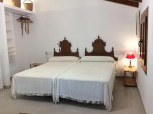 two beds in a room with white walls at Filoses 18A in Valldemossa