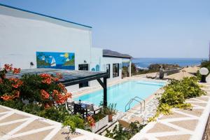 a villa with a swimming pool and a view of the ocean at Sea View Studios in Amoopi