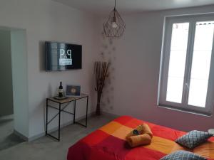 a bedroom with a bed and a tv on the wall at Bed and Breakfast P&P Nîmes-Centre in Nîmes