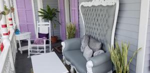 a couch and chair in front of a house at The Artist House in Key West