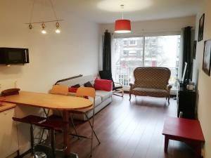 a living room with a couch and a table at Appartement T2 Hyper City Centre in Le Mans
