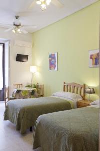 En eller flere senge i et værelse på Hostal Los Alpes