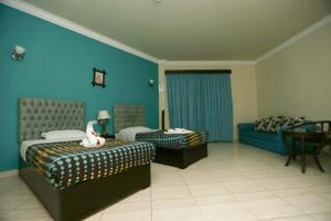 A bed or beds in a room at La Sirena Hotel & Resort - Families only
