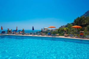 a large swimming pool with a view of the ocean at Casa Licia in Positano