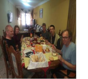 a group of people sitting around a table eating food at Mi Angeline in Sucre