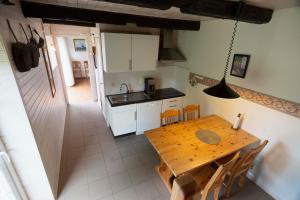 a kitchen and dining room with a wooden table at Törnholmen in Garnanäs