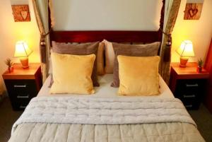 a bedroom with a large bed with two lamps at The Liverpool Pod Travel Hostel in Liverpool