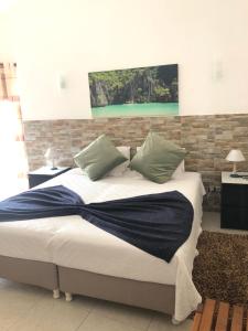 a bedroom with a bed with a blue blanket on it at Apartamentos Atalaia in Sagres