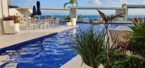 a swimming pool in a hotel with blue water at Miranda condo in Playa del Carmen