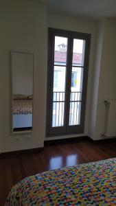 a bedroom with two large sliding glass doors and a bed at A casa dalla Fra 2 in Castelfranco Emilia