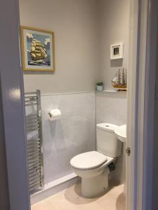 a bathroom with a white toilet and a sink at Rosebank in Spean Bridge