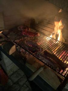 a grill with meat and other food on it at Rosa Marina in Scicli