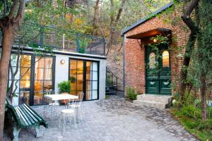 a patio with a table and chairs next to a building at Funicular Inn Apartments in Tbilisi City