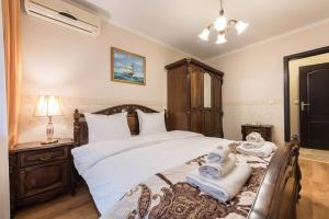 a bedroom with a bed with towels on it at Vazov Residence , two bedroom top centre apartment in Varna City