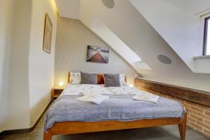 a bedroom with a large bed in a attic at Agnes - Apartments in Prague