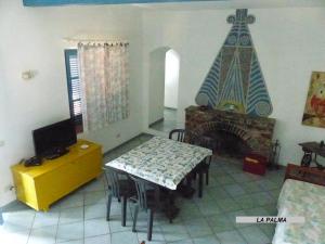 a living room with a table and a fireplace at Appartamenti Villa Lina in Nisporto