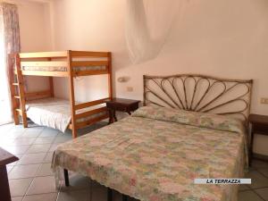 a bedroom with a bed and two bunk beds at Appartamenti Villa Lina in Nisporto