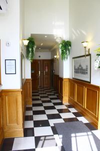 a hallway with a black and white checkered floor at Quest on Eden Serviced Apartments in Auckland