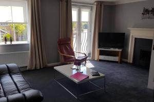 a living room with a couch and a chair at Rutland View in Oakham