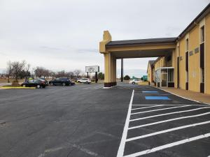 an empty parking lot in front of a building at Days Inn by Wyndham Lawton in Lawton