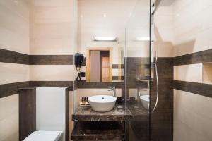 a bathroom with a sink and a shower at Hotel and SPA Moreni in Sofia