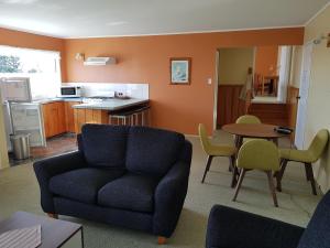a living room with a couch and a table at Seaview Norfolk Island in Burnt Pine
