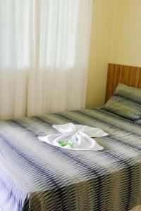 Ένα ή περισσότερα κρεβάτια σε δωμάτιο στο Araguaia Hotel