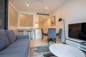 a living room with a couch and a table at Hope Street Apartments by CLLIX in Brisbane