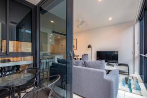 a living room with a couch and a table at Hope Street Apartments by CLLIX in Brisbane