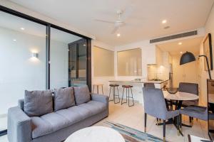 a living room with a couch and a table at Hope Street Apartments by CLLIX in Brisbane