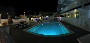 a swimming pool on a rooftop at night at Bird of Paradise Motel in North Wildwood